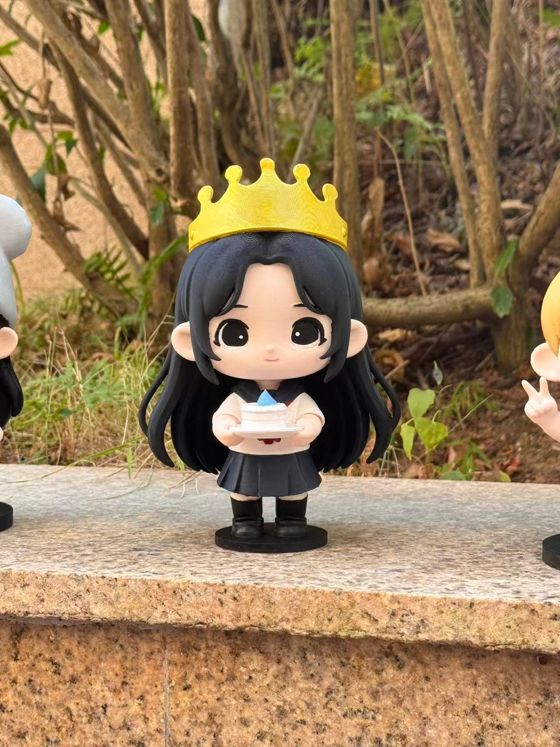 Outdoor custom chibi figurine with crown and black dress birthday styling