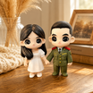 A hand holds a printed couple photo beside the matching custom WishFigure chibi couple figurines