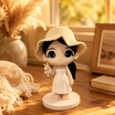 A hand holds a printed photo beside the matching custom WishFigure chibi display figurine
