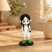 A hand holds a printed photo beside the matching custom WishFigure chibi figurine