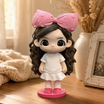 A hand holds a printed single portrait photo beside the matching custom WishFigure chibi figurine